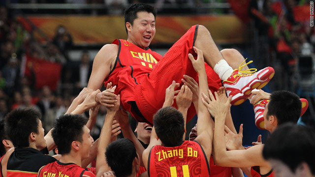 China captain Wang Zhizhi is lifted by his teammates after winning the basketball final in Guangzhou on Friday.