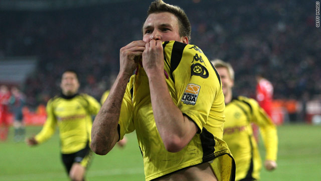 Kevin Grosskreutz's celebrates his injury time winner as Dortmund made it five wins in succession.
