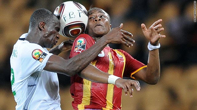 Burkina Faso's Mohamed Koffi, left, leaps for the ball with Ghana's Dede Ayew during Tuesday's match.