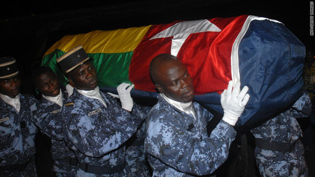 Togolese gendarmes carry the coffin of one of the shooting victims.