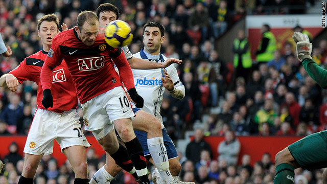 In-form England striker Wayne Rooney climbs to power home Manchester United's first goal against Portsmouth.