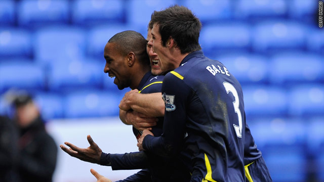 Jermain Defoe is mobbed by teammates after scoring Tottenham's equalizer at Bolton on Sunday.
