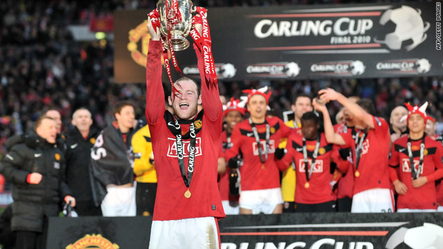 England and Manchester United striker Wayne Rooney lifts the Carling Cup trophy at Wembley stadium.