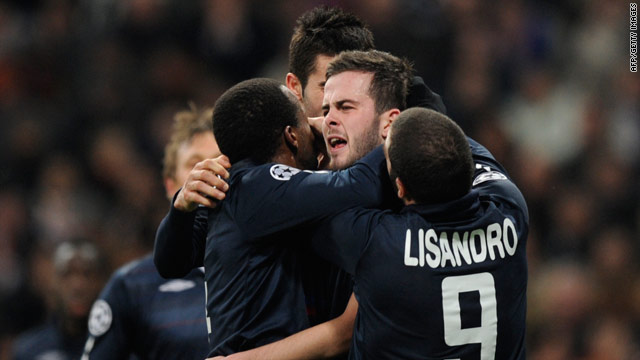 Lyon players rejoice at Miralem Pjanic's equalizing goal in the 1-1 draw at the Bernabeu Stadium.