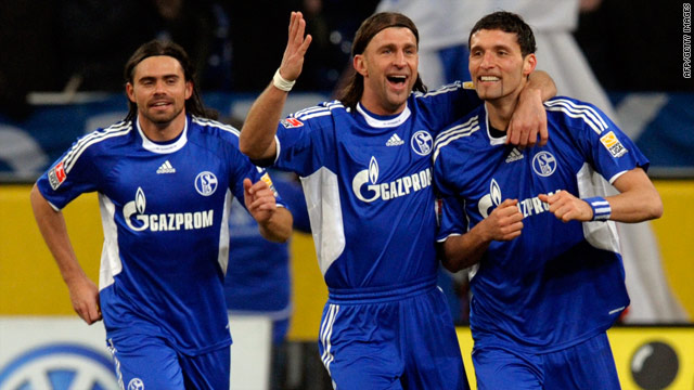 Kevin Kurany (right) celebrates his winning goal as Schalke beat Stuttgart to go back on top of the Bundesliga table.