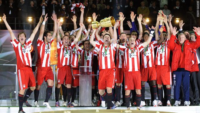 Mark van Bommel lifts the German Cup after Bayern Munich crushed Werder Bremen 4-0 in the final.