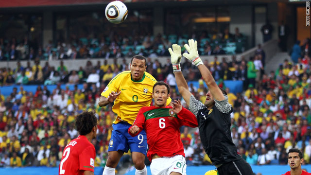 Brazil striker Luis Fabiano leaps to try and meet a cross in the company of Portuguese defenders.