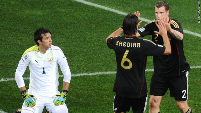 German goalscorers Sami Khedira and Marcell Jansen celebrate the latter's equalizing header against Uruguay.