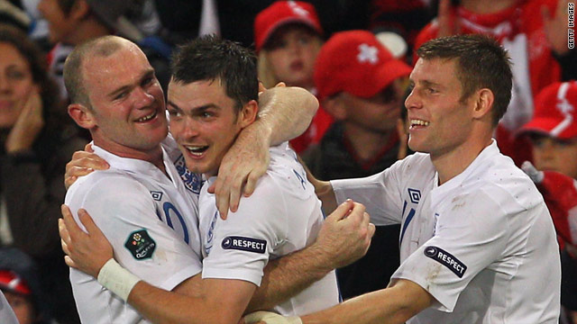 Wayne Rooney (L) is congratulated by Adam Johnson (C) and James Milner after scoring for England against Switzerland.