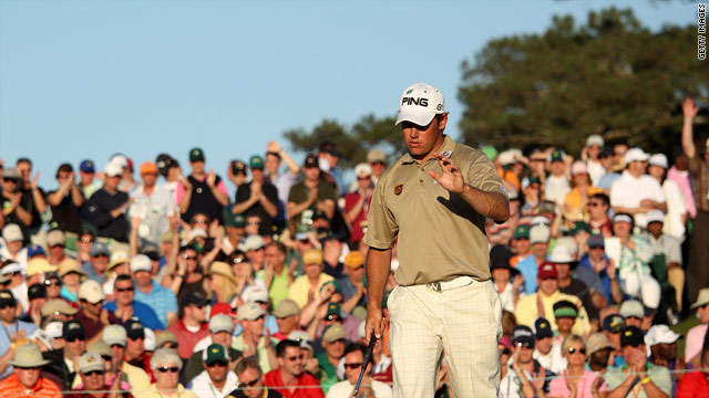 Westwood holes his par putt on the 18th to keep his one-shot lead over Phil Mickelson going into Sunday's final round at Augusta.