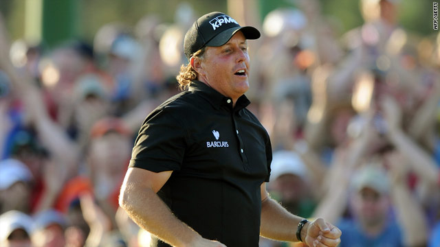 Mickelson celebrates his birdie putt on the 18th as he claims his third Masters title.