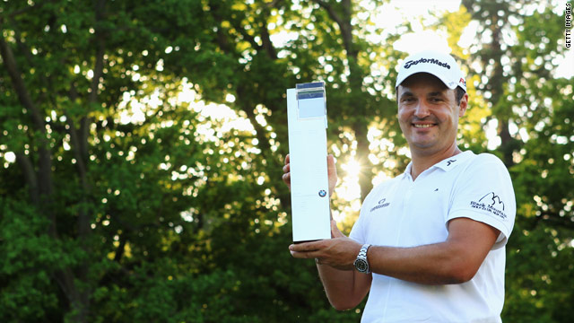 Simon Khan proudly displays his European PGA trophy after carding a final round 66 to snatch the title by one shot.