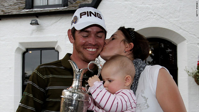 Louis Oosthuizen celebrates his seven-stroke victory at the British Open with his wife Nel-Mare and daughter Jana.