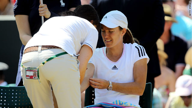 Justine Henin receives treatment on her elbow during her match with Kim Clijsters.