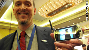 John Godfrey, of Samsung, shows off a demo mobile phone that can pick up and play local TV.