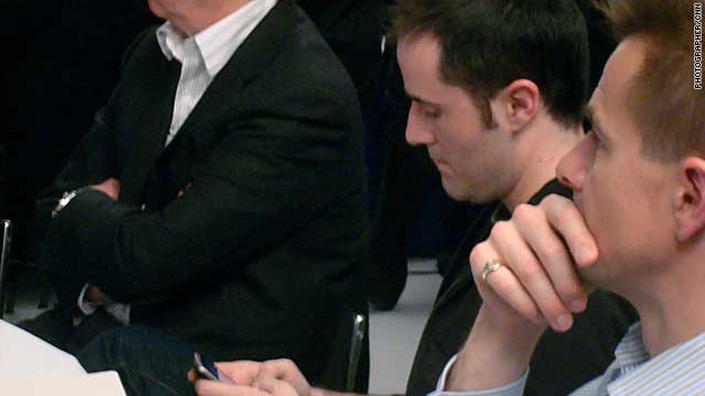 Twitter co-founder Evan Williams finds time to use his own service during the social media discussion at Davos.