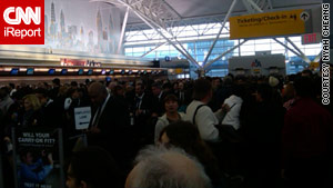 An iReport photo shows crowds at New York's John F. Kennedy airport.