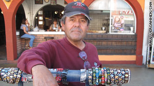 "Please tell them, the Americans, it's safe to come here," said Tijuana street vendor Juan Ramon Rocha.