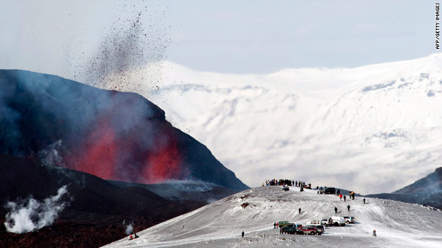 Tourists gather to watch lava spurt out of the site of a volcanic eruption at the Fimmvorduhals volcano near the Eyjafjallajokull glacier on March 27.