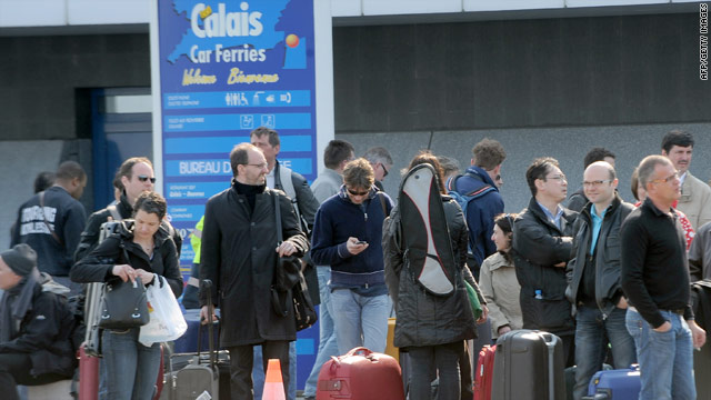 Travelers prepare to board a ferry to Dover, England, on Monday at the Calais harbor in France.