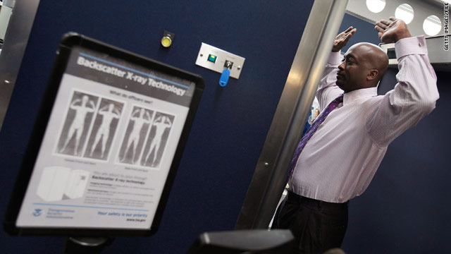 A TSA volunteer demonstrates a full-body scanner at Chicago's O'Hare International Airport last month.