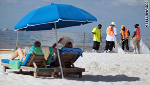 Workers clean up oil residue earlier this week on Orange Beach, Alabama.