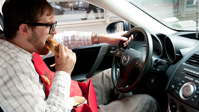 As Budget Travel staffer Nicholas DeRenzo demonstrates, the pocket on the BeltzBib can be used for stashing fries.