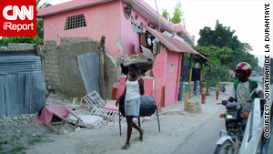 A damaged house in Haiti. Many Americans from Haiti are anxiously awaiting word from relatives.
