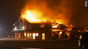 A house burns after being struck by a small plane Sunday in Belleville, Illinois.