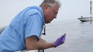 Ed Overton takes a simple oil sample about 10 miles off the coast of Louisiana.