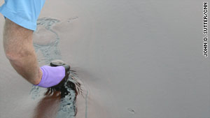 Overton dipped a jar into a sea that looks like it's covered in chocolate pudding.