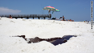 Tar balls and puddles of oil are reported on Alabama's Dauphin Island.