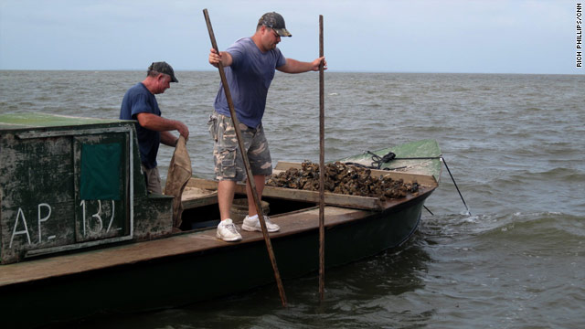 Oysterman Stephen Peterson uses giant tongs to harvest oysters from Apalachicola Bay, Florida on Sunday, June 6.