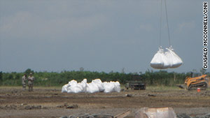 The National Guard lifts sandbags in Buras, Louisiana, on June 11 to fill in gaps between barrier islands.