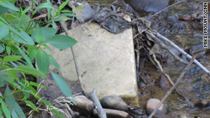 Discarded grave stones were lying in a stream bed at Arlington National Cemetery for years.