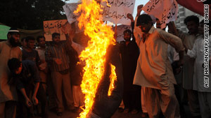 Pakistani Muslims burn an effigy of cartoonist Molly Norris during a protest in May in Karachi, Pakistan.