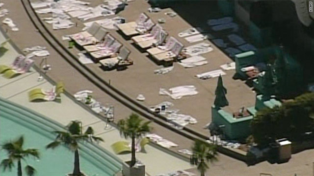 Rumpled towels sit on abandoned lounge chairs after the pool area at the MGM Grand was evacuated Friday.