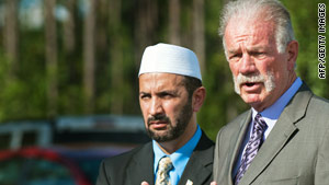 The Rev. Terry Jones, right, with a Florida imam, Mohammad Musri, says plans to burn Qurans have been called off.