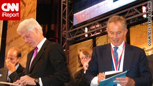 Former President Clinton and ex-British Prime Minister Tony Blair sign autographs Monday in Philadelphia.