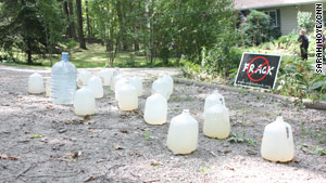 Jugs of water sit in front of a house in Dimock, Pennsylvania, where residents are suing Cabot Oil and Gas Corp.