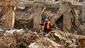 A worker searches through debris at ground zero.