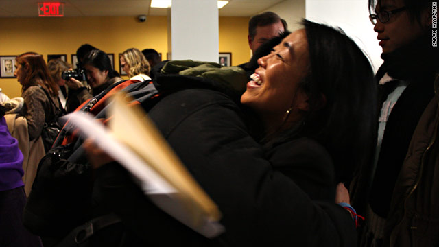 Helen Gym, a board member for Asian Americans United, hugs a student after Wednesday's announcement.