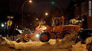 Sanitation workers clear snow at a Brooklyn intersection on Wednesday, December 29.