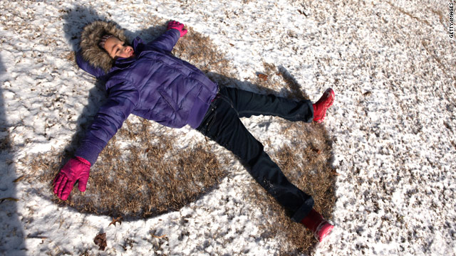 Ariana Ingle, 6, makes a snow angel in a dusting of white Friday at Piedmont Park in Atlanta, Georgia.