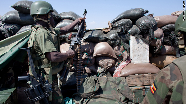 An African Union Mission in Somalia watches a building where a suspected Al-Shebab sniper hides at the junction K4 (Kilometer 4), a strategic roundabout in Mogadishu on January 26, 2010.