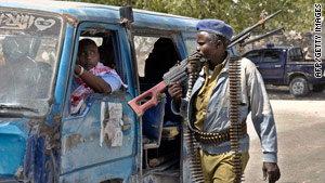 A Somali government soldier patrols the streets of southern Mogadishu on February 17, 2010.