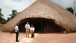 Tourists pose in 2006 outside the Tombs of the Buganda Kings near Kampala, Uganda.