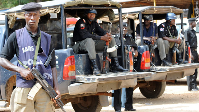 Policemen stand guard at the police headquarters in Jos, Nigeria, on March 10, three days after the massacre.