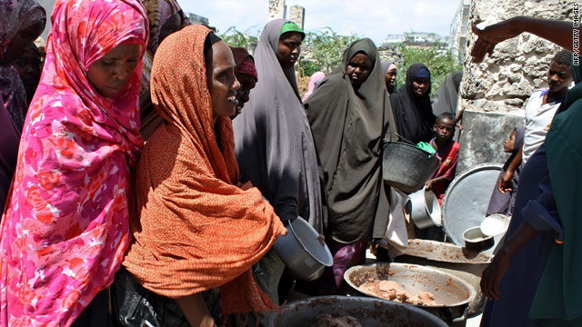 Internally displaced Somali women queue for food aid at a distribution center in Mogadishu.