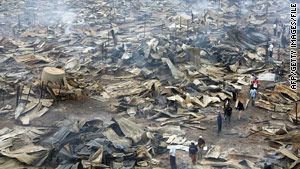 A clothes market smolders in Nairobi, Kenya, after being set afire in December 2007 in post-election violence.